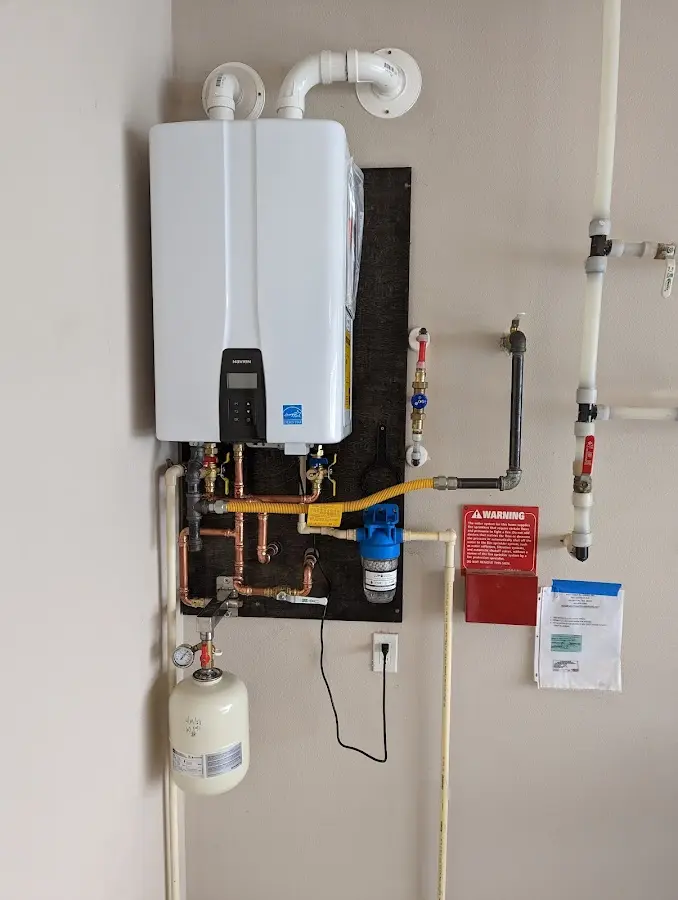 Professional plumber installing copper piping in a Brices Creek home